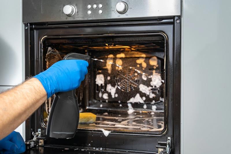 Deep cleaning Sydney — scrubbing inside an oven