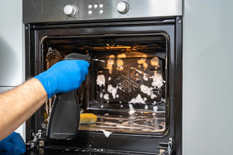 Deep cleaning Sydney — scrubbing inside an oven