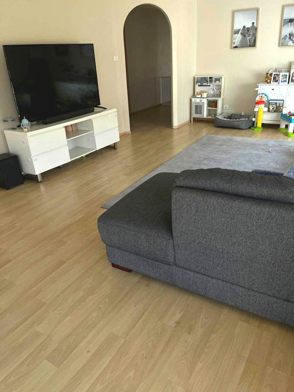 Living room timber floor cleaned around the furniture
