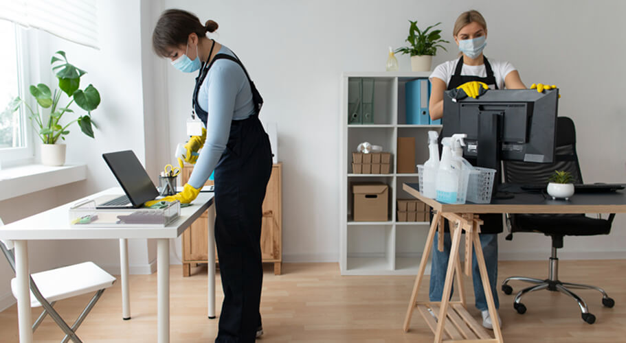 Two uniformed cleaners working through a property